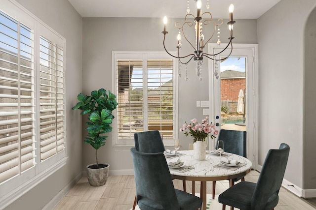 dining area with a healthy amount of sunlight and an inviting chandelier