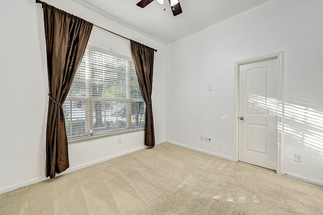 empty room with light colored carpet and ceiling fan