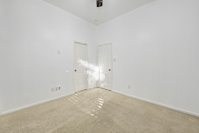 empty room featuring ceiling fan and carpet