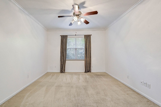 carpeted empty room featuring ceiling fan and ornamental molding