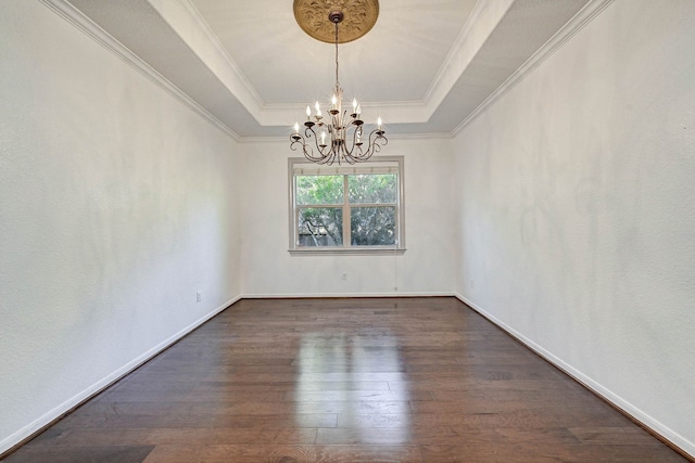 unfurnished room with crown molding, dark hardwood / wood-style flooring, a notable chandelier, and a raised ceiling