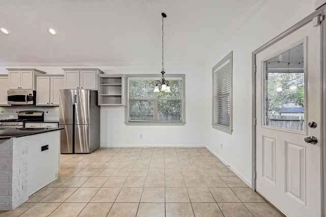 kitchen with pendant lighting, a chandelier, light tile patterned floors, and appliances with stainless steel finishes