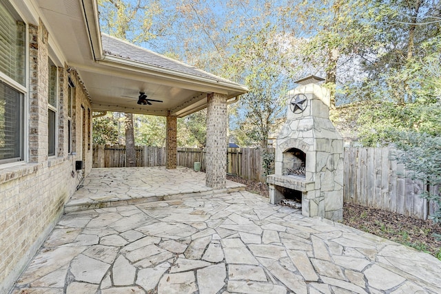 view of patio / terrace featuring ceiling fan and exterior fireplace