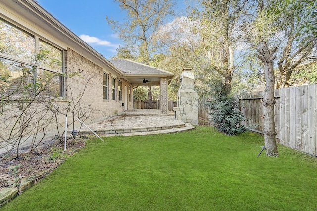 view of yard featuring ceiling fan and a patio area