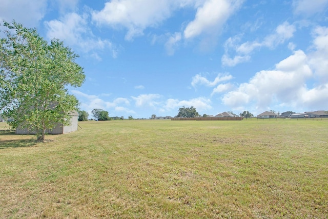 view of yard with a rural view