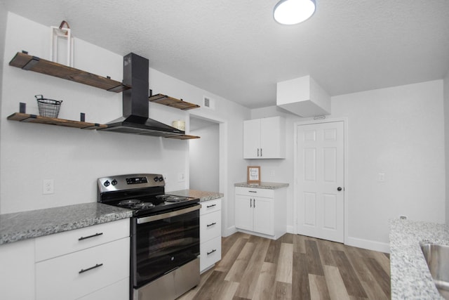 kitchen featuring a textured ceiling, stainless steel electric range oven, island exhaust hood, white cabinets, and light wood-type flooring