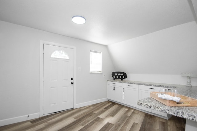 entrance foyer with light wood-type flooring and vaulted ceiling