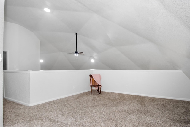 additional living space with ceiling fan, carpet, and vaulted ceiling