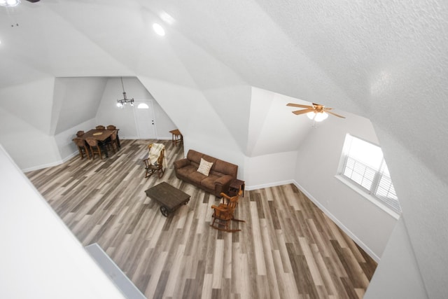 additional living space featuring vaulted ceiling, ceiling fan, and wood-type flooring