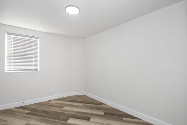 empty room with hardwood / wood-style floors