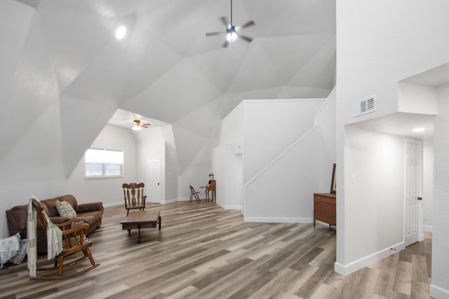 sitting room with ceiling fan, light hardwood / wood-style floors, and lofted ceiling