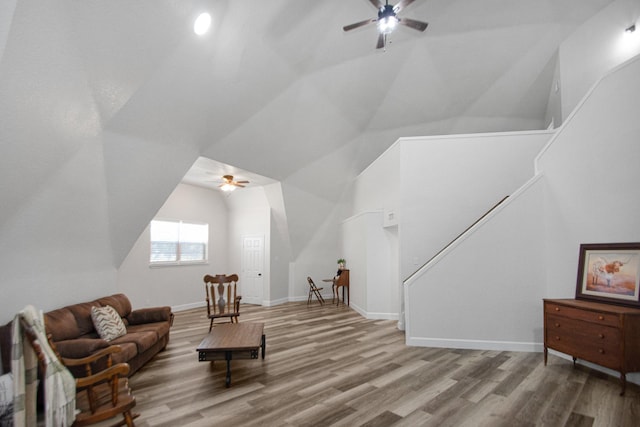 living area featuring wood-type flooring, vaulted ceiling, and ceiling fan