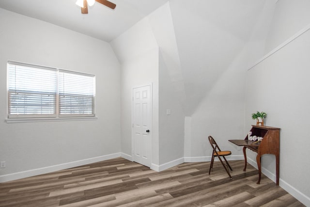 interior space featuring ceiling fan, dark hardwood / wood-style flooring, and lofted ceiling