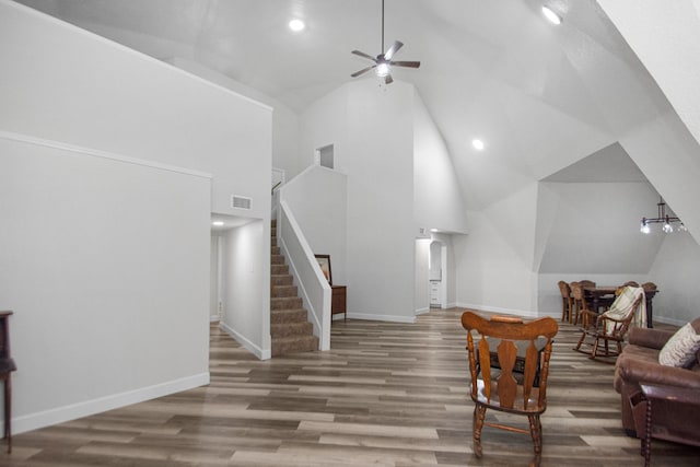 living area with ceiling fan, high vaulted ceiling, and wood-type flooring