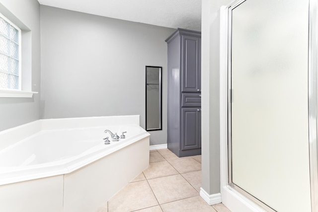 bathroom with plus walk in shower and tile patterned flooring