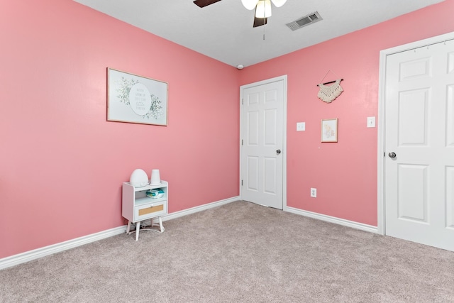 spare room featuring ceiling fan and light colored carpet