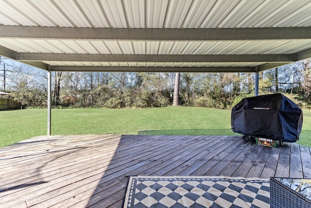 wooden terrace featuring a yard and area for grilling