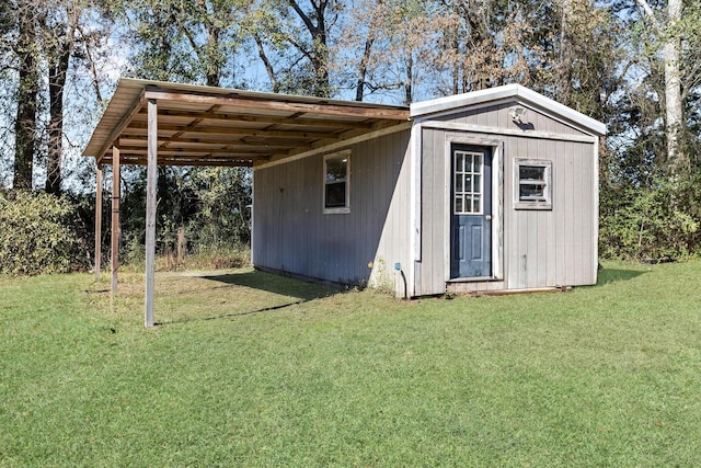 view of outbuilding with a yard