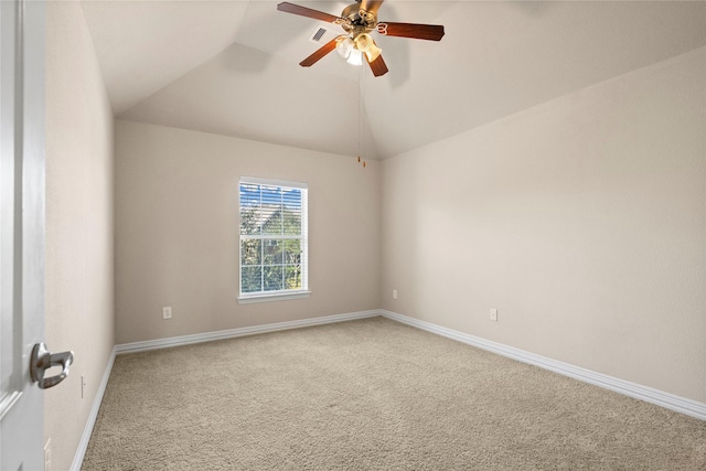 empty room featuring ceiling fan, carpet flooring, and lofted ceiling