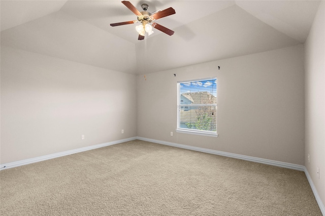 spare room with ceiling fan, vaulted ceiling, and carpet