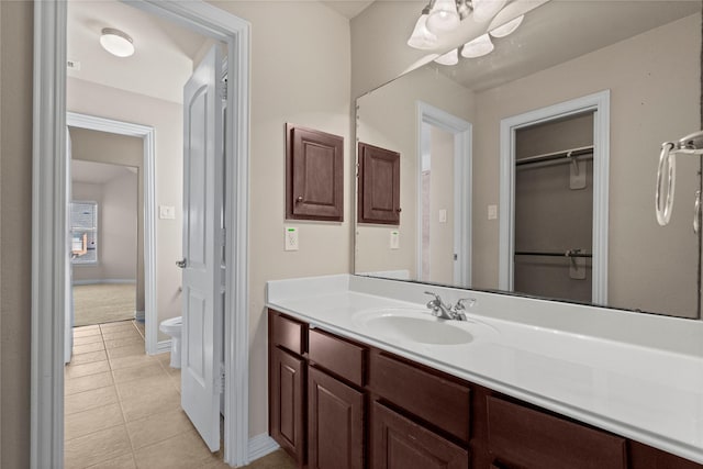 bathroom featuring vanity, toilet, and tile patterned floors