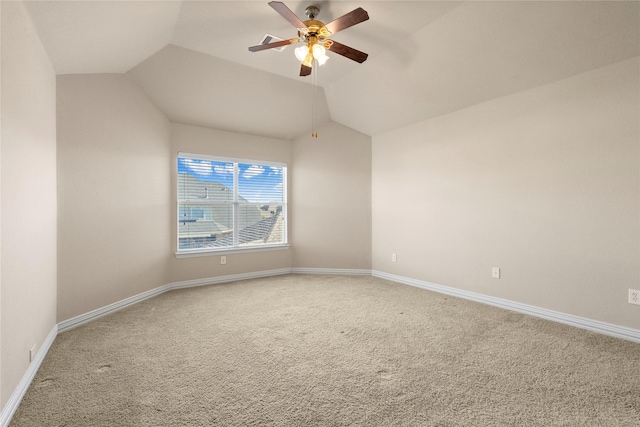 spare room with carpet floors, vaulted ceiling, and ceiling fan