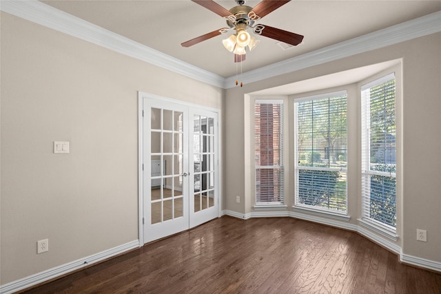 spare room with crown molding, dark wood-type flooring, ceiling fan, and french doors