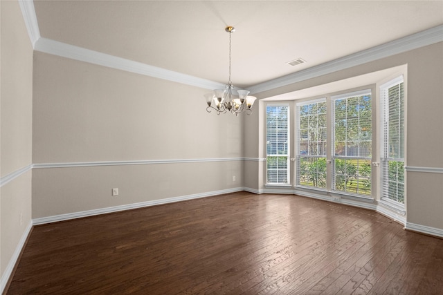 spare room with ornamental molding, a chandelier, and dark hardwood / wood-style flooring