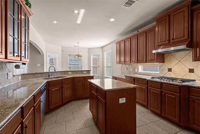 kitchen with a center island, decorative light fixtures, stainless steel appliances, sink, and light tile patterned floors