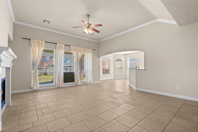 unfurnished living room with ceiling fan, crown molding, and light tile patterned flooring