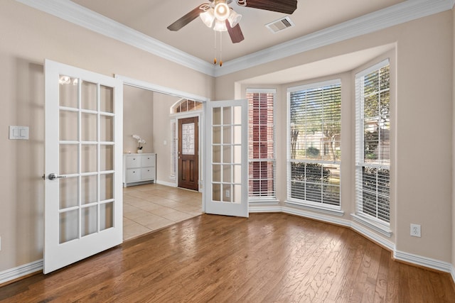 2511 Orchid Creek Dr, Pearland, TX 77584 - empty room featuring french doors, wood-type flooring, crown molding, and a ceiling fan