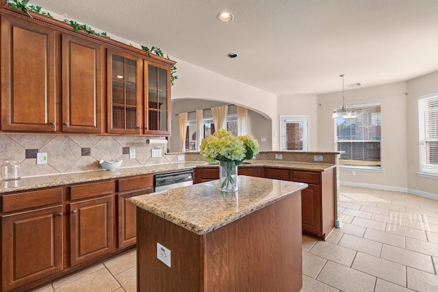2511 Orchid Creek Dr, Pearland, TX 77584 - kitchen with a kitchen island, decorative backsplash, dishwasher, recessed lighting, and light stone countertops