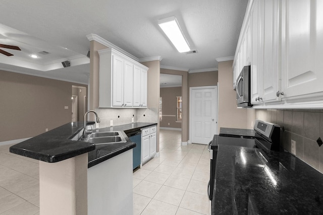 kitchen featuring ornamental molding, appliances with stainless steel finishes, kitchen peninsula, and white cabinets