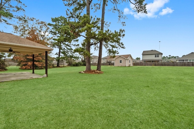 view of yard with a patio and ceiling fan