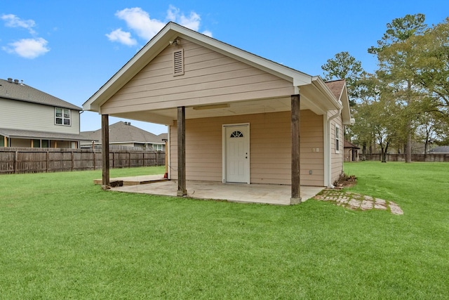 rear view of house with a patio area and a lawn