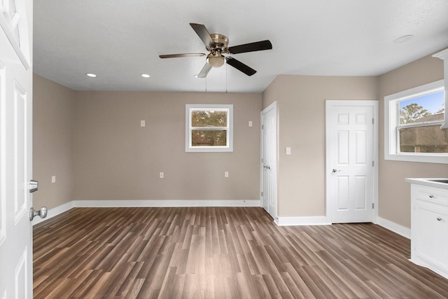 interior space with ceiling fan, dark hardwood / wood-style floors, and a healthy amount of sunlight