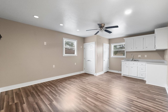 kitchen featuring white cabinetry, plenty of natural light, sink, and wood-type flooring