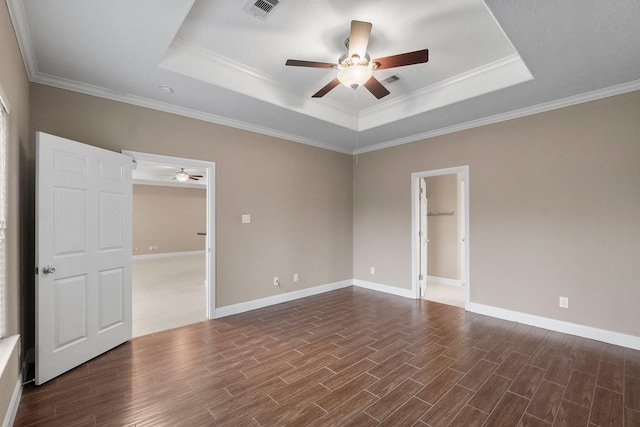 spare room featuring ornamental molding, a raised ceiling, and ceiling fan