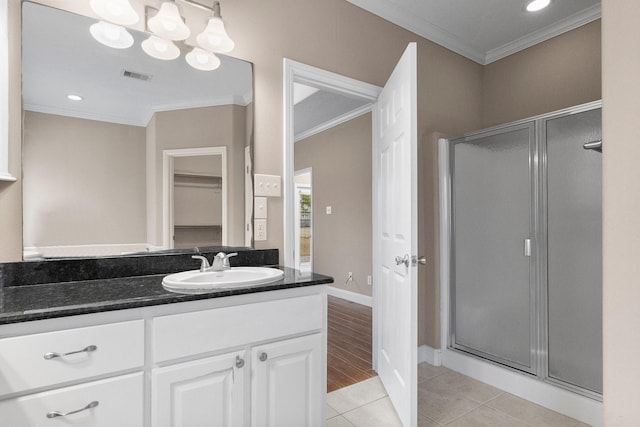 bathroom featuring crown molding, tile patterned floors, and walk in shower