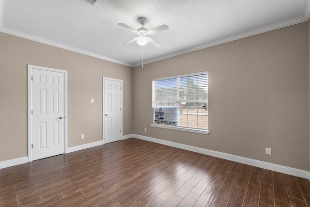 empty room featuring crown molding, dark wood-type flooring, a textured ceiling, and ceiling fan