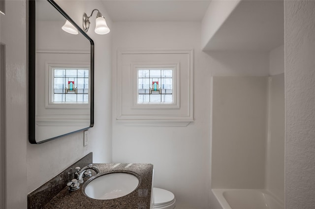 bathroom with toilet and vanity