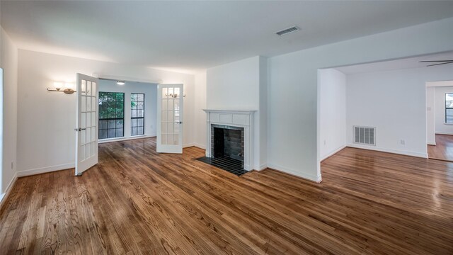 unfurnished living room featuring hardwood / wood-style flooring and french doors