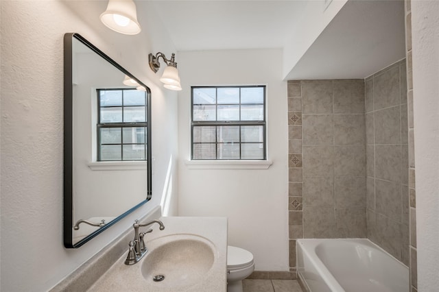 full bathroom with sink, toilet, tiled shower / bath combo, and tile patterned flooring