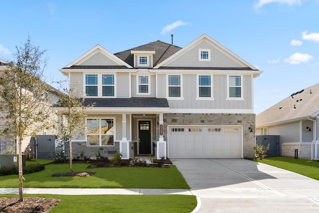 view of front of house featuring a garage and a front lawn