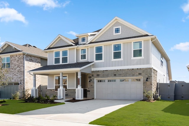 craftsman-style house featuring a garage, a front lawn, and a porch