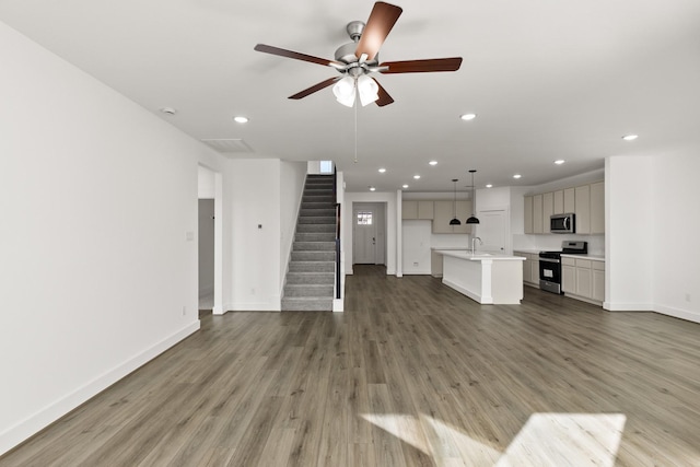 unfurnished living room featuring hardwood / wood-style floors and ceiling fan