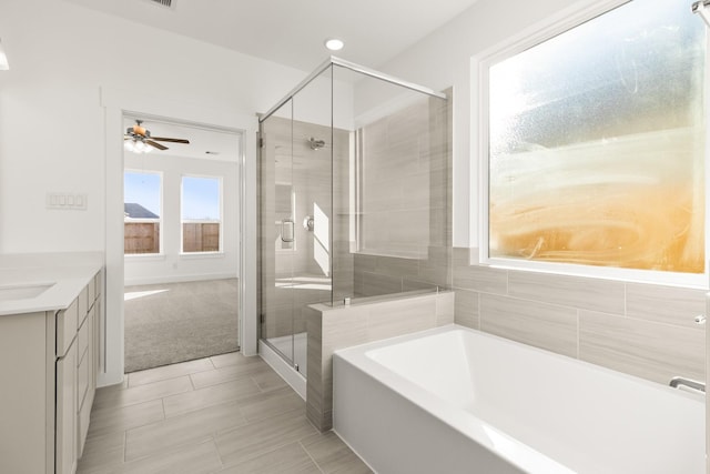 bathroom featuring separate shower and tub, tile patterned flooring, ceiling fan, and vanity