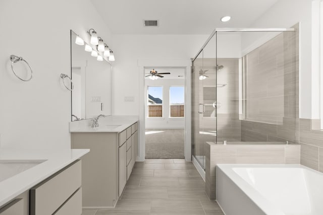 bathroom featuring independent shower and bath, ceiling fan, tile patterned floors, and vanity