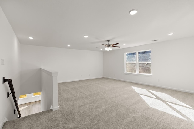 unfurnished room featuring ceiling fan and light colored carpet