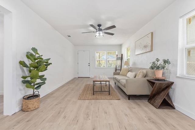 living room with ceiling fan and light hardwood / wood-style flooring